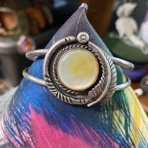 Unmarked, old native, sterling silver cuff bracelet with yellow shell
